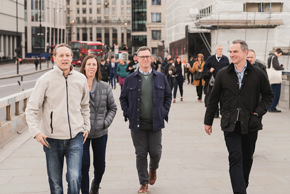 Four colleagues walking through London