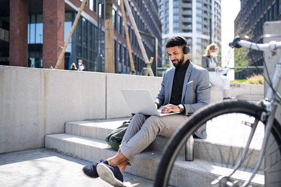 man sitting outside with laptop