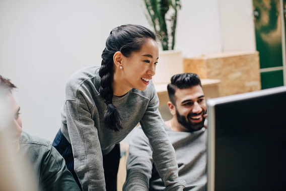 Group of people looking at computer